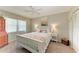 Cozy bedroom featuring a bed with white wood frame, bedside tables and large bright window at 3213 Mercer Rd, Bradenton, FL 34207