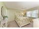 Comfortable bedroom with floral bedding, ceiling fan, and a view to the outside at 3213 Mercer Rd, Bradenton, FL 34207
