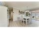 Cozy dining area featuring white table and chairs next to a glass door at 3213 Mercer Rd, Bradenton, FL 34207