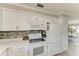 Kitchen with white cabinets, modern countertops, and stainless steel appliances at 3213 Mercer Rd, Bradenton, FL 34207