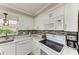Kitchen featuring white cabinets, modern countertops, and stainless steel appliances at 3213 Mercer Rd, Bradenton, FL 34207
