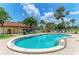 Sparkling community pool with comfortable lounge chairs for relaxation, surrounded by tropical landscaping at 3213 Mercer Rd, Bradenton, FL 34207