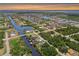 Wide aerial view of neighborhood canals, waterway, and homes near Tampa Bay during sunset at 3500 Liberty St, Port Charlotte, FL 33948