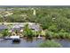 Aerial view showcases home's backyard pool, canal dock, and lush landscaping at 3500 Liberty St, Port Charlotte, FL 33948