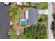 Aerial view of home with screened-in pool, canal access, dock, boat lift and a long driveway at 3500 Liberty St, Port Charlotte, FL 33948
