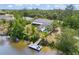 The home has a backyard pool, a dock and mature landscaping on a canal at 3500 Liberty St, Port Charlotte, FL 33948
