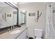 Modern bathroom featuring a large framed mirror, vanity, and a tiled shower at 3500 Liberty St, Port Charlotte, FL 33948