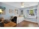 Charming bedroom with a built-in window seat, wood floors, and bright blue walls at 3500 Liberty St, Port Charlotte, FL 33948