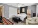 Bright bedroom featuring neutral paint, an accent wall, ceiling fan, and a window at 3500 Liberty St, Port Charlotte, FL 33948