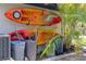 Exterior wall with two kayaks mounted, containers, and palm trees next to the side of the house at 3500 Liberty St, Port Charlotte, FL 33948