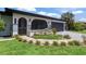 Inviting front exterior with arched entryway, fresh landscaping, and vibrant curb appeal at 3500 Liberty St, Port Charlotte, FL 33948