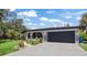 Charming single-Gathering home with a well-maintained front yard, mature landscaping, and a two car garage at 3500 Liberty St, Port Charlotte, FL 33948
