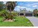 Charming single-story home featuring a well-manicured front lawn and an attached two-car garage at 3500 Liberty St, Port Charlotte, FL 33948