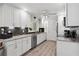 Updated white kitchen with stainless steel appliances, granite countertops and a pantry at 3500 Liberty St, Port Charlotte, FL 33948