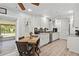 Charming kitchen open to a dining area with a view of a beautifully landscaped backyard at 3500 Liberty St, Port Charlotte, FL 33948