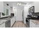 Renovated white kitchen with stainless steel appliances, granite countertops and a pantry at 3500 Liberty St, Port Charlotte, FL 33948