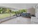 Relax in this covered lanai with comfortable seating and views of the lush backyard and waterway at 3500 Liberty St, Port Charlotte, FL 33948