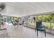 Entertain guests in this covered lanai with an outdoor dining set and view of the pool and manicured yard at 3500 Liberty St, Port Charlotte, FL 33948