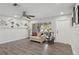 Bright living room with a large window, stylish decor, and durable floors at 3500 Liberty St, Port Charlotte, FL 33948