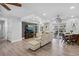 Open-concept living room with a large TV, dining area, and access to the outdoors at 3500 Liberty St, Port Charlotte, FL 33948