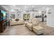 Open-concept living room with a large TV, dining area, and access to the outdoors at 3500 Liberty St, Port Charlotte, FL 33948