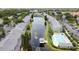 Aerial view of a well-maintained community with a long pond, pool, and ample parking at 396 Countryside Key Blvd, Oldsmar, FL 34677