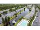 Aerial view of a well-maintained community with a long pond, pool, and ample parking at 396 Countryside Key Blvd, Oldsmar, FL 34677