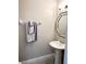 Elegant powder room featuring a pedestal sink, decorative mirror and soft lighting at 396 Countryside Key Blvd, Oldsmar, FL 34677