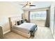 The primary bedroom features a large window, ceiling fan and neutral decor at 396 Countryside Key Blvd, Oldsmar, FL 34677