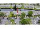 A bird's eye view of the community townhomes with ample parking spots and beautiful landscaping around the community pond at 396 Countryside Key Blvd, Oldsmar, FL 34677