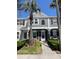 Inviting two-story townhome with a gray exterior, black shutters, and maintained front lawn at 396 Countryside Key Blvd, Oldsmar, FL 34677