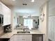Stylish kitchen with white cabinetry, stainless steel appliances, and a clear view into the living area at 396 Countryside Key Blvd, Oldsmar, FL 34677