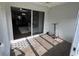 A covered patio features sliding glass doors and wood-look flooring at 396 Countryside Key Blvd, Oldsmar, FL 34677