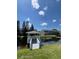 Scenic view of a pond featuring a dock, water lilies, and lush shoreline vegetation at 396 Countryside Key Blvd, Oldsmar, FL 34677