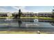 A serene pond view with a fountain and surrounding townhome community at 396 Countryside Key Blvd, Oldsmar, FL 34677