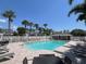 Community pool surrounded by lounge chairs, palm trees, and well-maintained buildings at 396 Countryside Key Blvd, Oldsmar, FL 34677