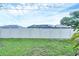 A backyard with a green lawn and white fence surrounding a screened-in pool at 408 Fletcher St, Port Charlotte, FL 33954