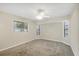 Bedroom featuring light walls, neutral carpet, and three windows at 408 Fletcher St, Port Charlotte, FL 33954