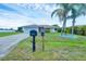 Beautiful single-story home featuring a well-manicured lawn and a spacious two-car garage at 408 Fletcher St, Port Charlotte, FL 33954