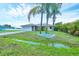 Lovely single-story home with a two-car garage, complemented by lush landscaping and mature palm trees at 408 Fletcher St, Port Charlotte, FL 33954