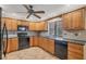 Kitchen featuring wood cabinets and black appliances at 408 Fletcher St, Port Charlotte, FL 33954