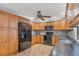 Bright kitchen featuring wood cabinets and black appliances at 408 Fletcher St, Port Charlotte, FL 33954