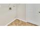 A laundry room featuring a white door, tile floors, and hookups for a washer and dryer at 408 Fletcher St, Port Charlotte, FL 33954