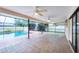 Spacious screened patio with ceiling fans overlooking a sparkling pool, ideal for outdoor entertaining at 408 Fletcher St, Port Charlotte, FL 33954