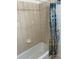 Tiled bathtub and shower with a decorative shower curtain at 4353 Hidden River Rd, Sarasota, FL 34240