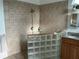 Bathroom featuring glass block accents and tiled shower at 4353 Hidden River Rd, Sarasota, FL 34240