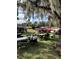 Community gathering with cars, tables, and local residents beneath trees at 4353 Hidden River Rd, Sarasota, FL 34240