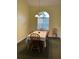 Simple dining room with matching table and chairs illuminated by chandelier at 4353 Hidden River Rd, Sarasota, FL 34240