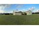 Quaint single-story home with lush landscaping and a metal outbuilding on a large lot at 4353 Hidden River Rd, Sarasota, FL 34240