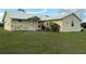 Charming single-story home with a metal roof, manicured lawn, and lush landscaping at 4353 Hidden River Rd, Sarasota, FL 34240